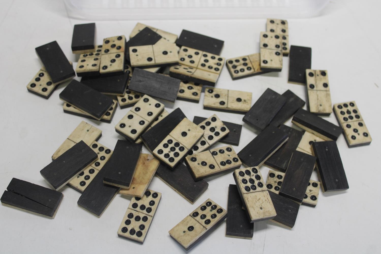 A selection of antique bone and ebony dominoes