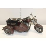 A tin plate model of a motorbike and side cart