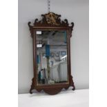 An antique wooden framed wall mirror 69cm tall