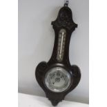 An antique oak cased barometer