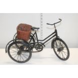 A vintage model of a three wheeled bicycle