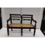 A miniature wooden and cane Bergere seat 'no postage available' 62cm x 32cm x 48cm