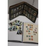 A stamp album & selection of cigarette collectors cards