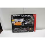 A boxed Formula chaser racing set