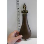 A rare copper powder flask with a measuring device