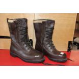 A pair of brown leather class 2 chainsaw boots size 9