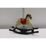 A vintage miniature child's wooden rocking horse