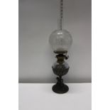 An antique glass and brass oil lamp with a Hinks duplex burner