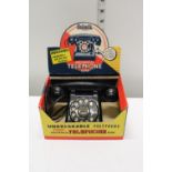 A vintage child's mechanical telephone bank