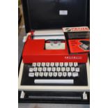 A vintage Petite International portable typewriter. Postage unavailable