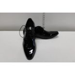 A new pair of men's Dobell patent shoes sized 11