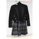 A Scottish kilt and waistcoat and jacket set. Kilt is 30/32 waist, jacket & vest is small size.