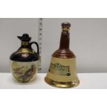 Two empty porcelain whiskey decanters