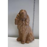 A large terracotta dog figurine