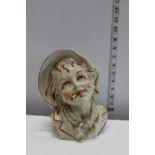 A heavy ceramic bust figure of a young boy