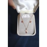 A 9ct gold necklace and earring set with real garnet decoration
