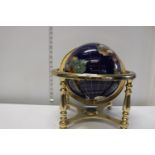 A brass and gemstone globe