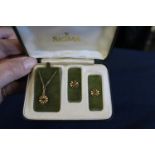 A 9ct gold necklace and earring set in the form of flowers