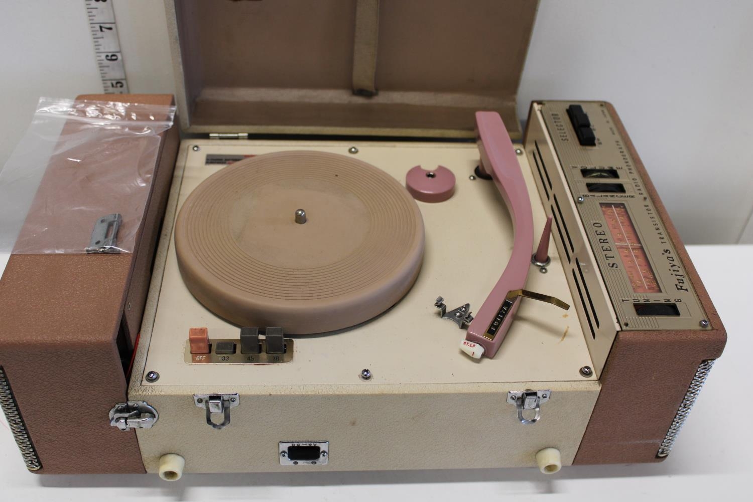 A vintage fujiya's transistor radio and photograph