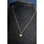 A 9ct gold diamond and sapphire pendant on a nine 9ct chain