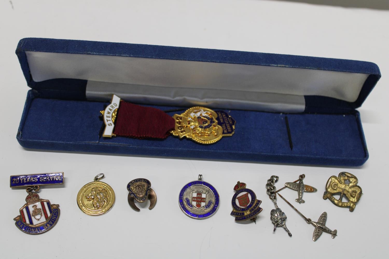 A selection of assorted enamel badges and medals including silver examples