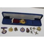 A selection of assorted enamel badges and medals including silver examples