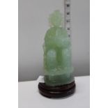 A Chinese green glass oriental figure