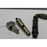 Three vintage metal whistles including police and scouts