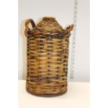 A heavy salt glazed bottle with wicker carrying basket Postage unavailable