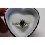 A 9ct heart shaped Sapphire cluster ring Size R