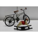 A metal bicycle model and vintage miniature wooden rocking horse