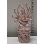 A pink glazed Oriental deity