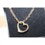 A 9ct gold chain and floating heart pendant