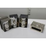 A selection of boxed silver plated napkin rings and silver plated matchbox holder