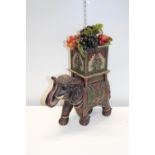 A large resin Indian elephant and faux fruit. AF