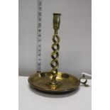 A large antique brass chamber stick