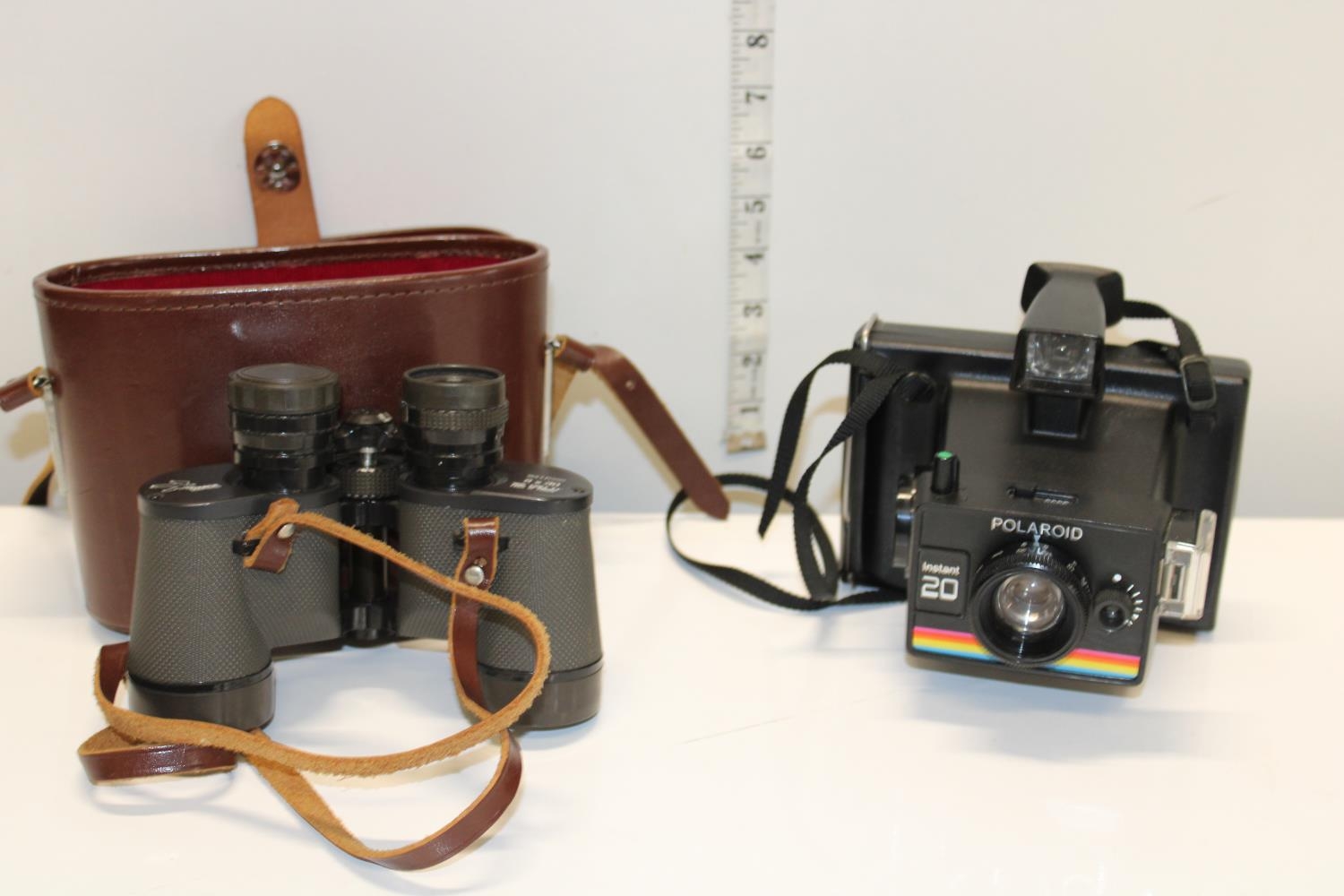 A vintage Polaroid camera & pair of Ozeck binoculars