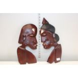 A pair of wooden hand carved wall hanging busts