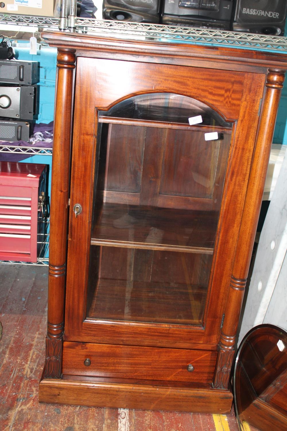 A quality mahogany two shelf display cabinet with under drawer & key. postage unavailable. Slight