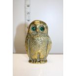 An antique brass owl form posy/spill holder with green glass eyes