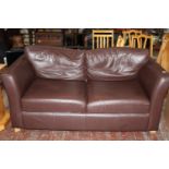 A brown two seater sofa. Postage unavailable