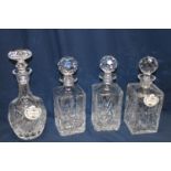 Four cut glass decanters and labels
