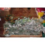 A box of Christmas themed foliage decorations