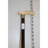 A antique Victorian bone handled walking cane with hallmarked silver collar. postage unavailable