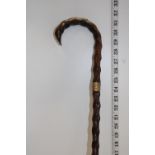 A antique walking cane with yellow metal band. postage unavailable