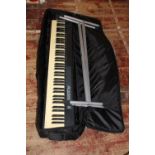 A Alesis Q88 electronic keyboard and stand. postage unavailable