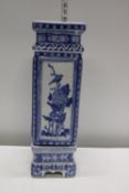 A large tall Chinese blue and white porcelain vase on stand. Postage unavailable