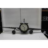 A unusual very large metal aeroplane wall clock with 5ps applied to the face. Postage unavailable