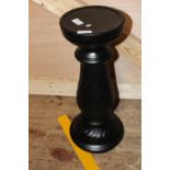 A black ceramic planter stand. postage unavailable