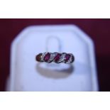 A 9ct ring with red and white stones 2.31g